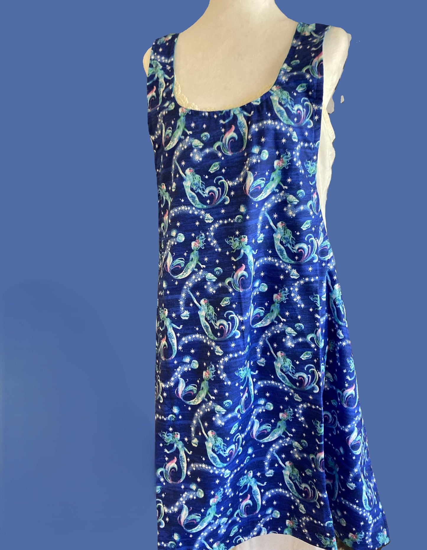 Mermaids swimming in blue water on an apron.