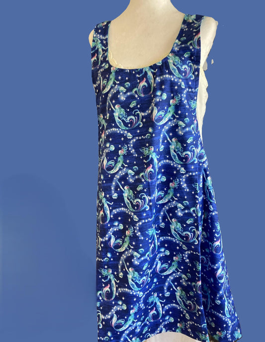Mermaids swimming in blue water on an apron.